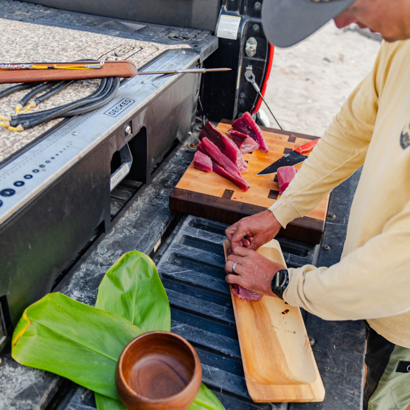 Danny Bolton cutting fresh sashimi on the tailgate of his truck.