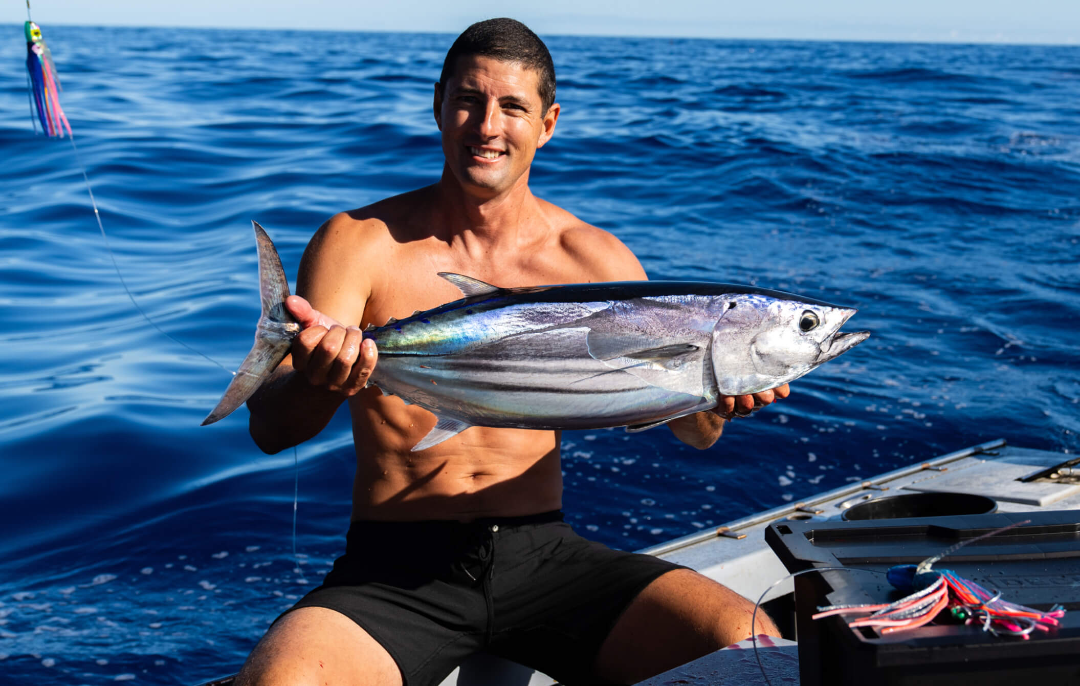 Danny Bolton smiling big with a tuna.