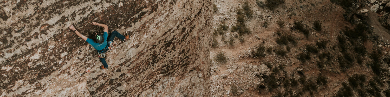 Jackson Marvell climbing up a rock face.