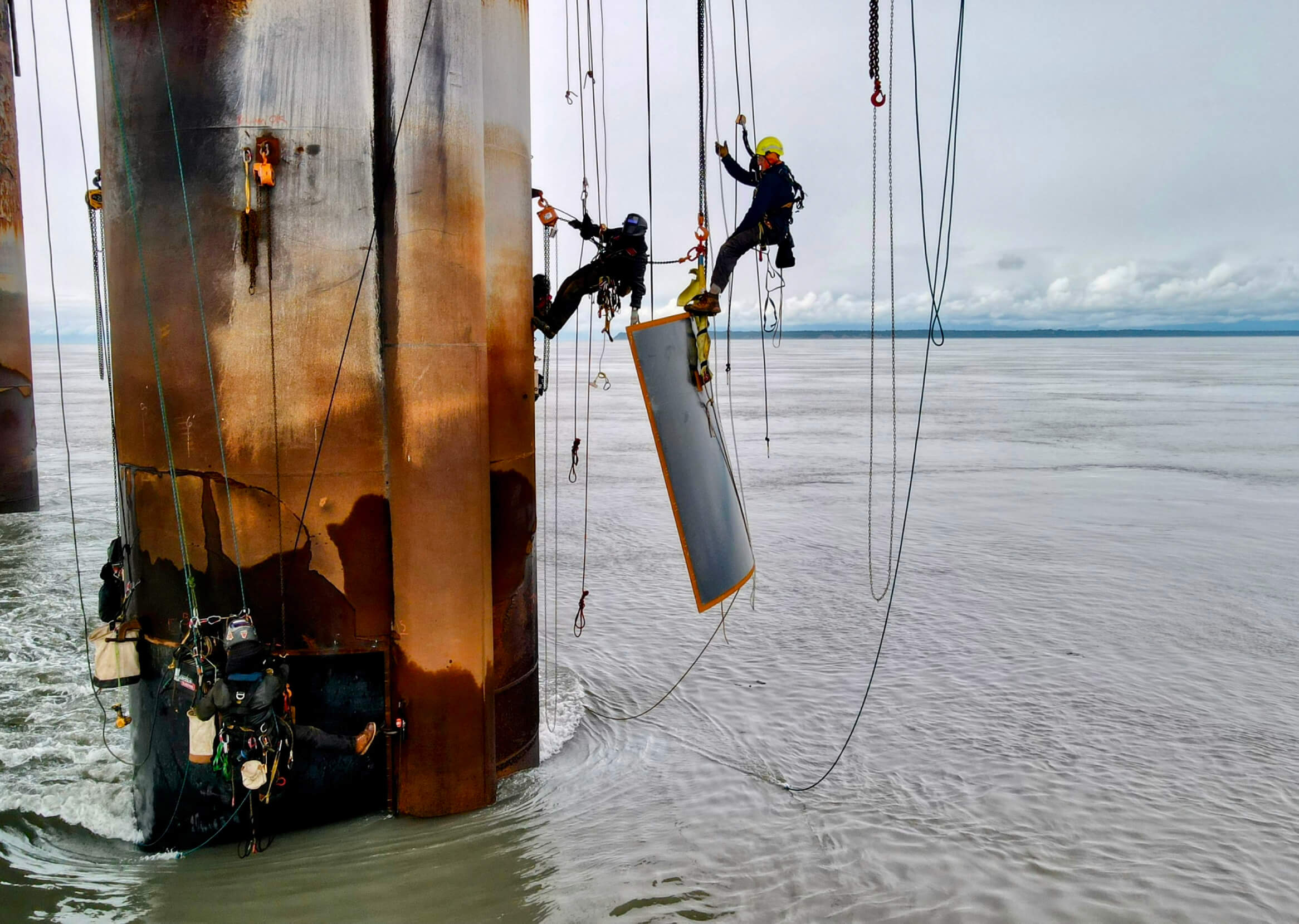 Jackson Marvell and others repelling from an offshore oil rig.