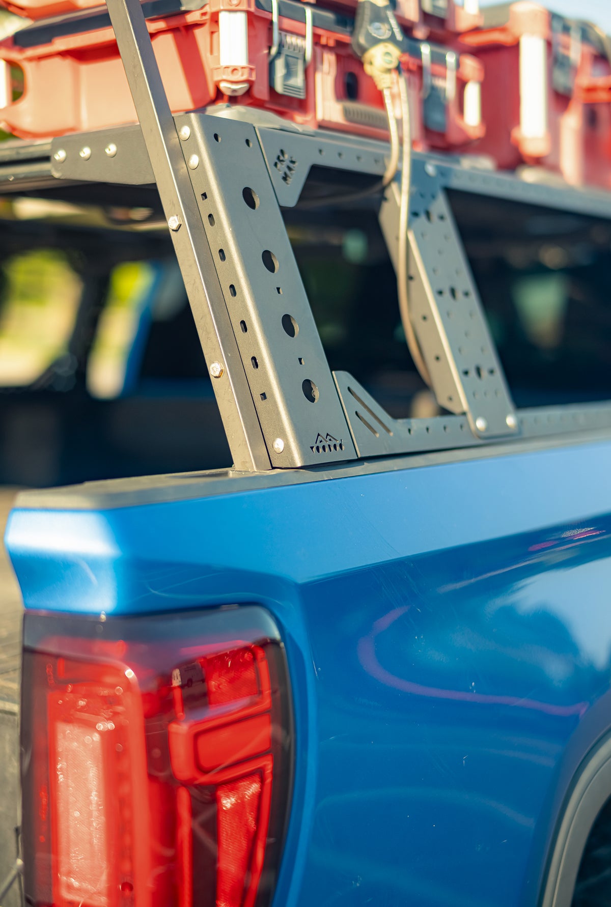 Close-up of the metal bed rack on Thor Rippey’s blue truck, with red storage cases secured above the bed.