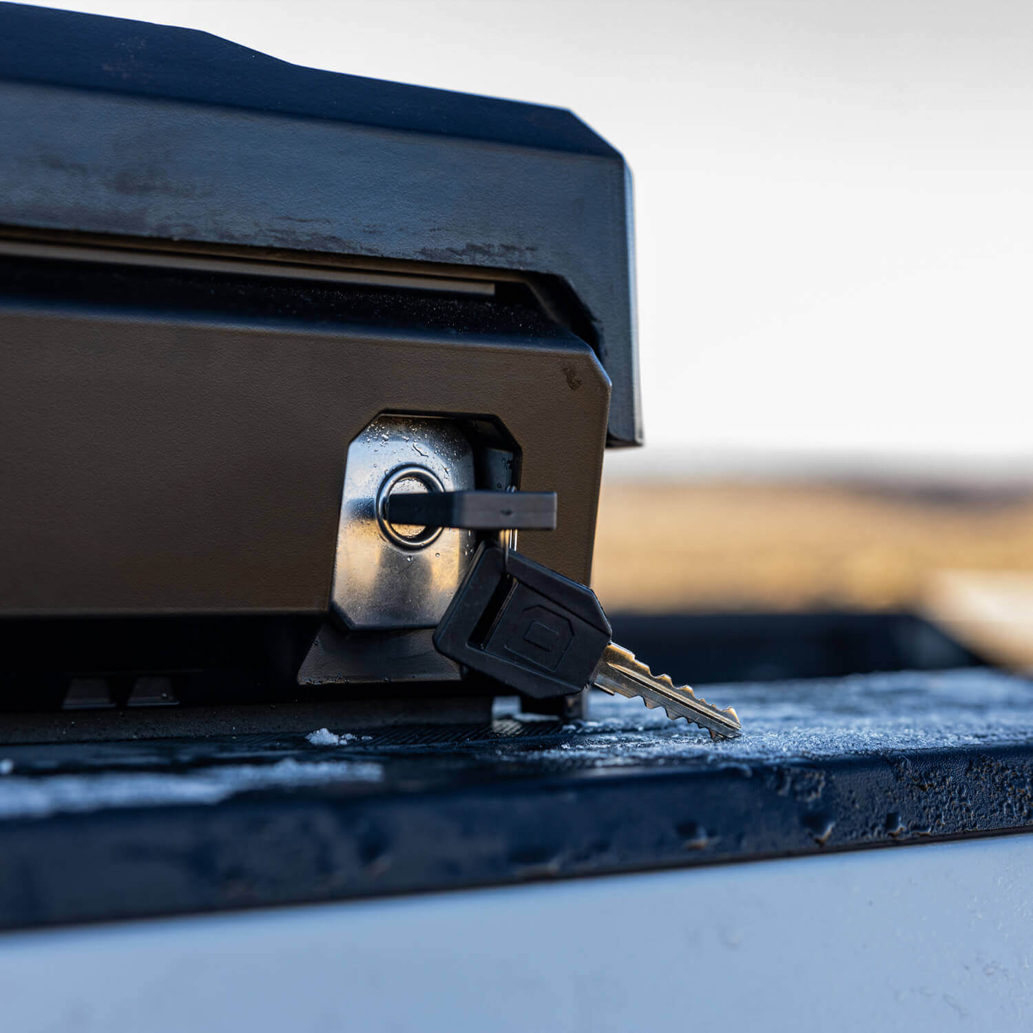 Key inserted into the DECKED Tool Box lock on the driver side of a truck bed.