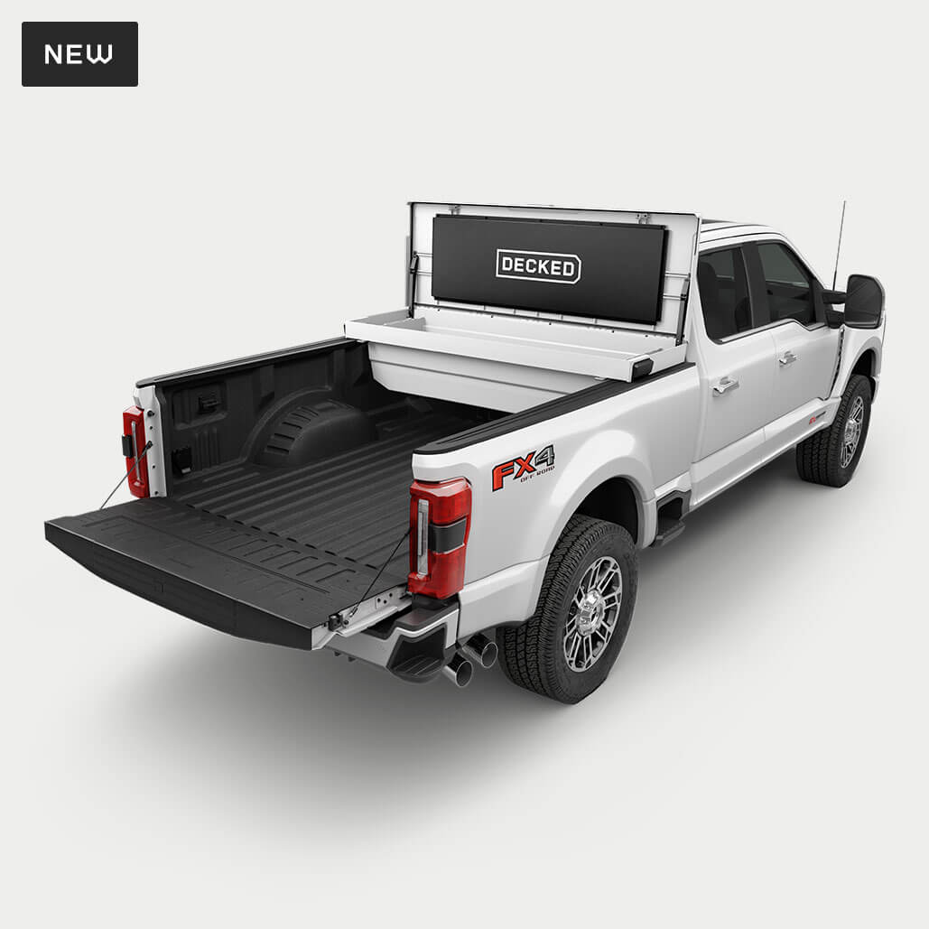 An open white Tool Box in the bed of a Ford F-350. 