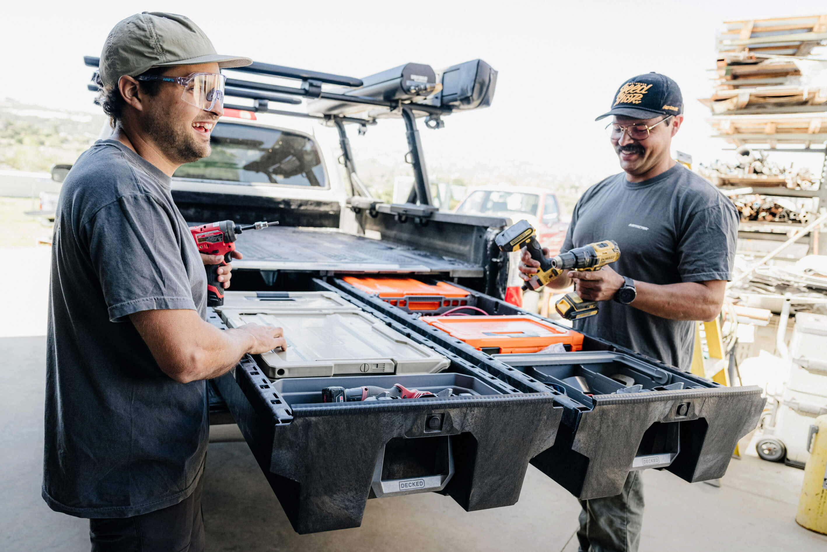 Two men grabbing tools out of a Drawer System at a lumber yard.